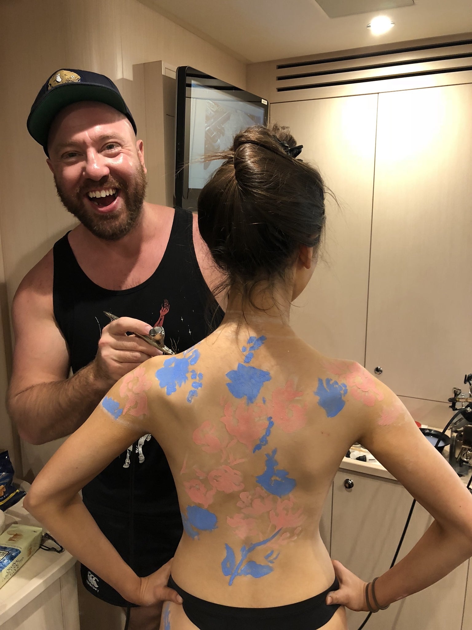 London body painter Neil Hughes body painting a female model as a geisha aboard the Lionheart yacht in Monaco