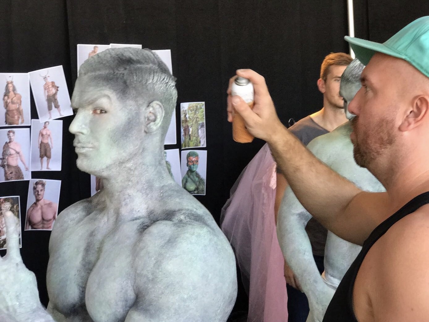 Neil Hughes Body painting a male model with an airbrush