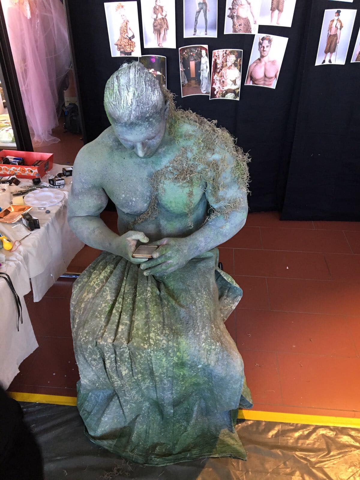 Male fitness model body painted behind the scenes as a living statue stone moss enchanted garden party woodland fairy tale body painters for events