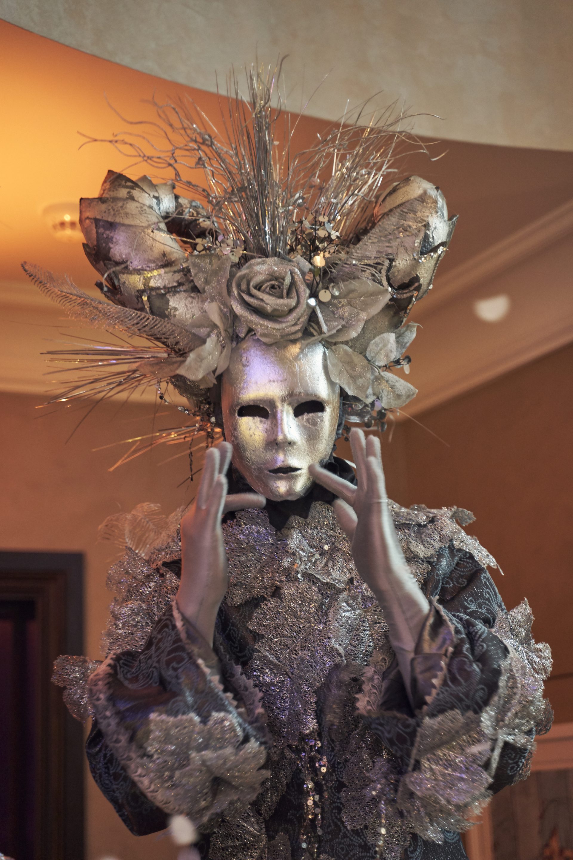Icy Venetian masked stilt walker