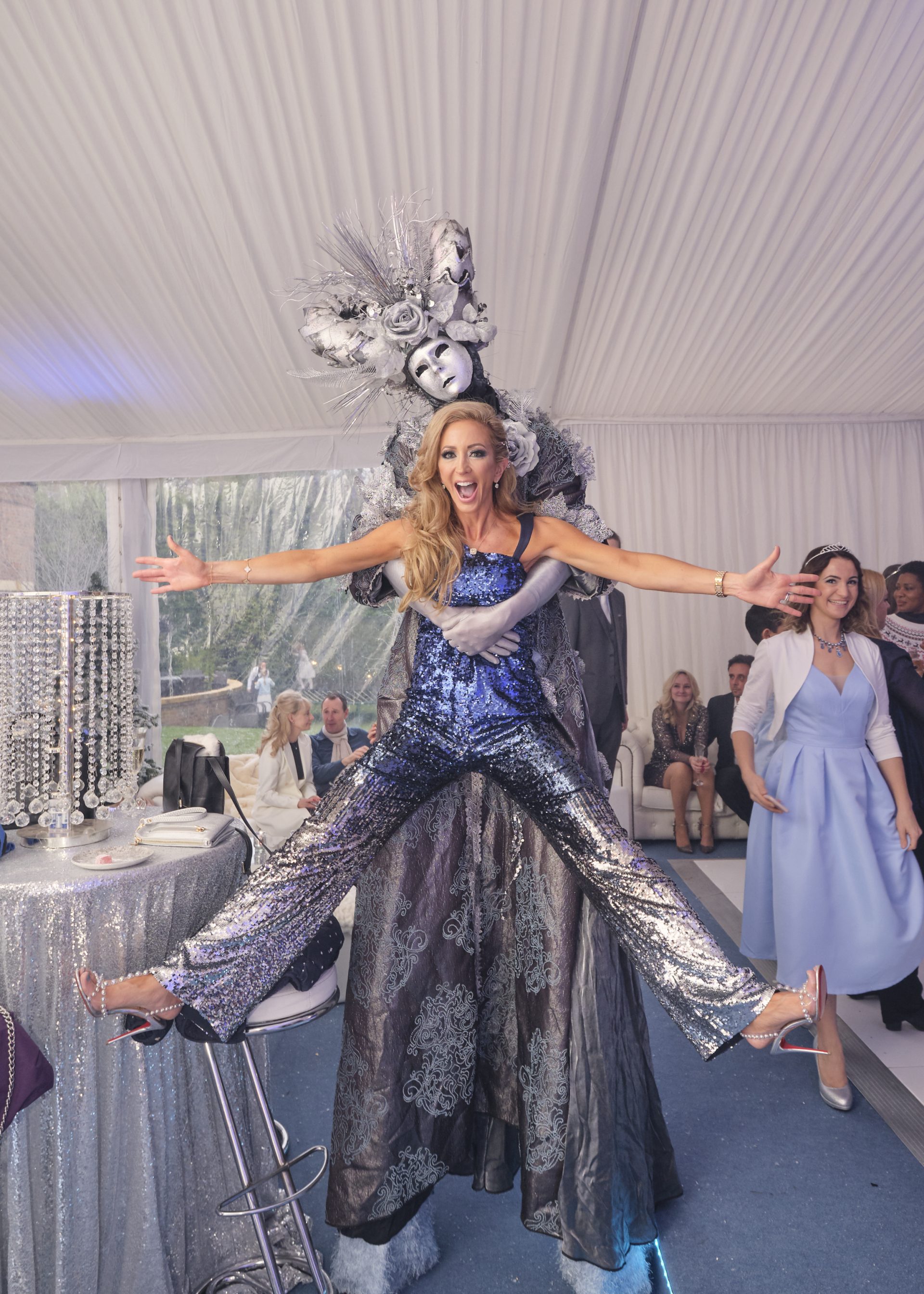 Frosted stilt walker for events picking up pretty lady