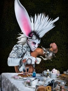 Image of a model dressed at the white rabbit with body paint and prosthetics and big headdress