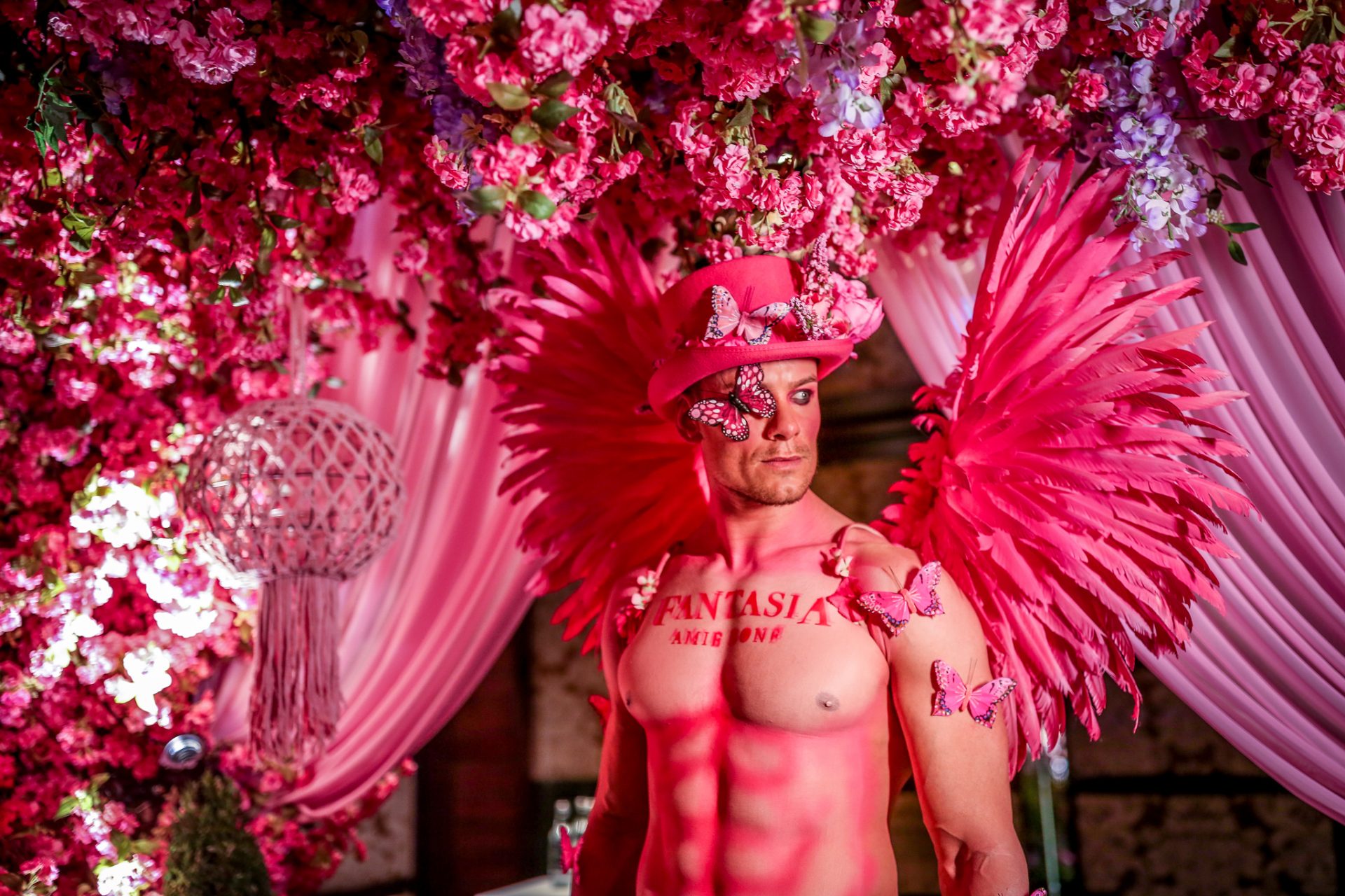Pink feathered wings male model body paint Victoria secret flowers enchanted garden Pink feathered wings male model body paint Victoria secret flowers enchanted garden