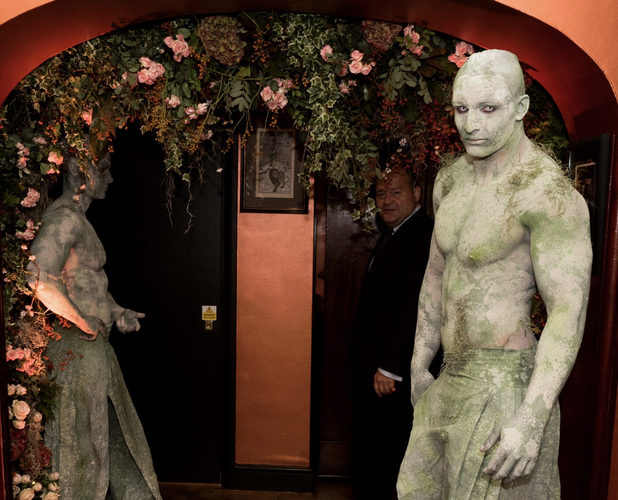 Body painted enchanted garden statues living male model A body painted male physique model as a stone statue