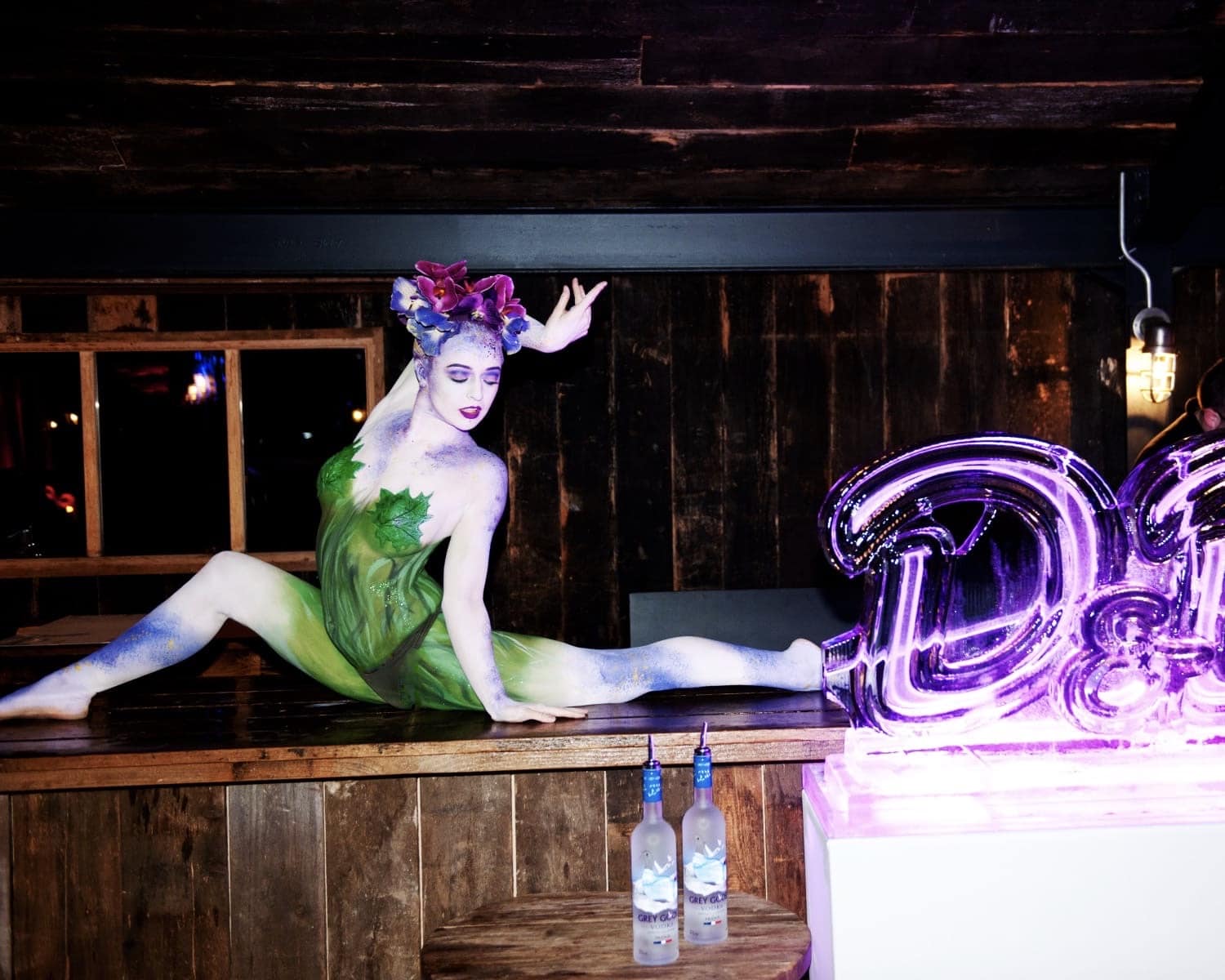 Body Painted Flower Circus A body painted circus performer, painted like an orchid performer contortion on the bar of soho farm house uk