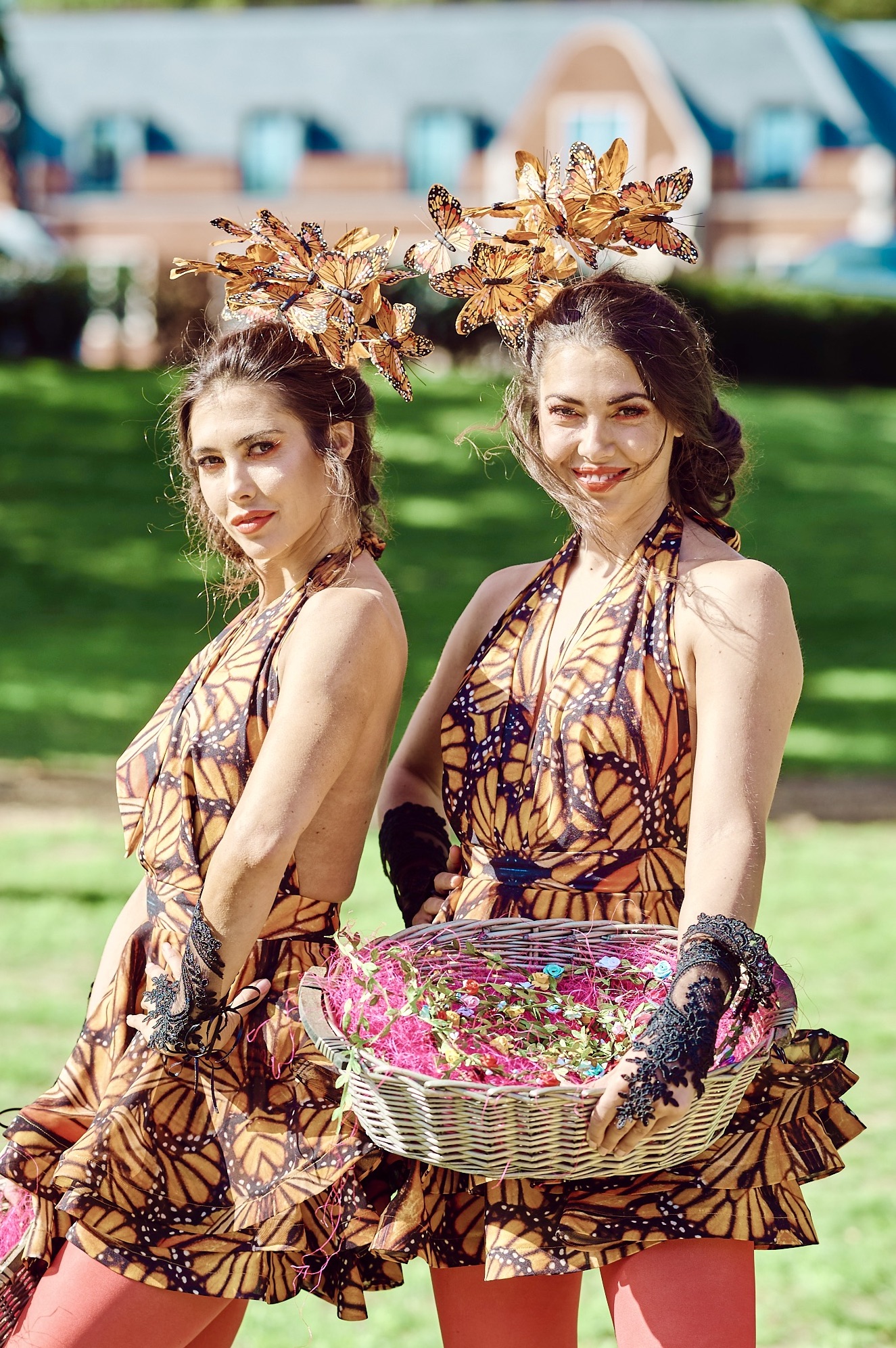 Butterflies Sophie and Eloise Lovell as event hosts dressed as monarch butterflies at an enchanted garden party.