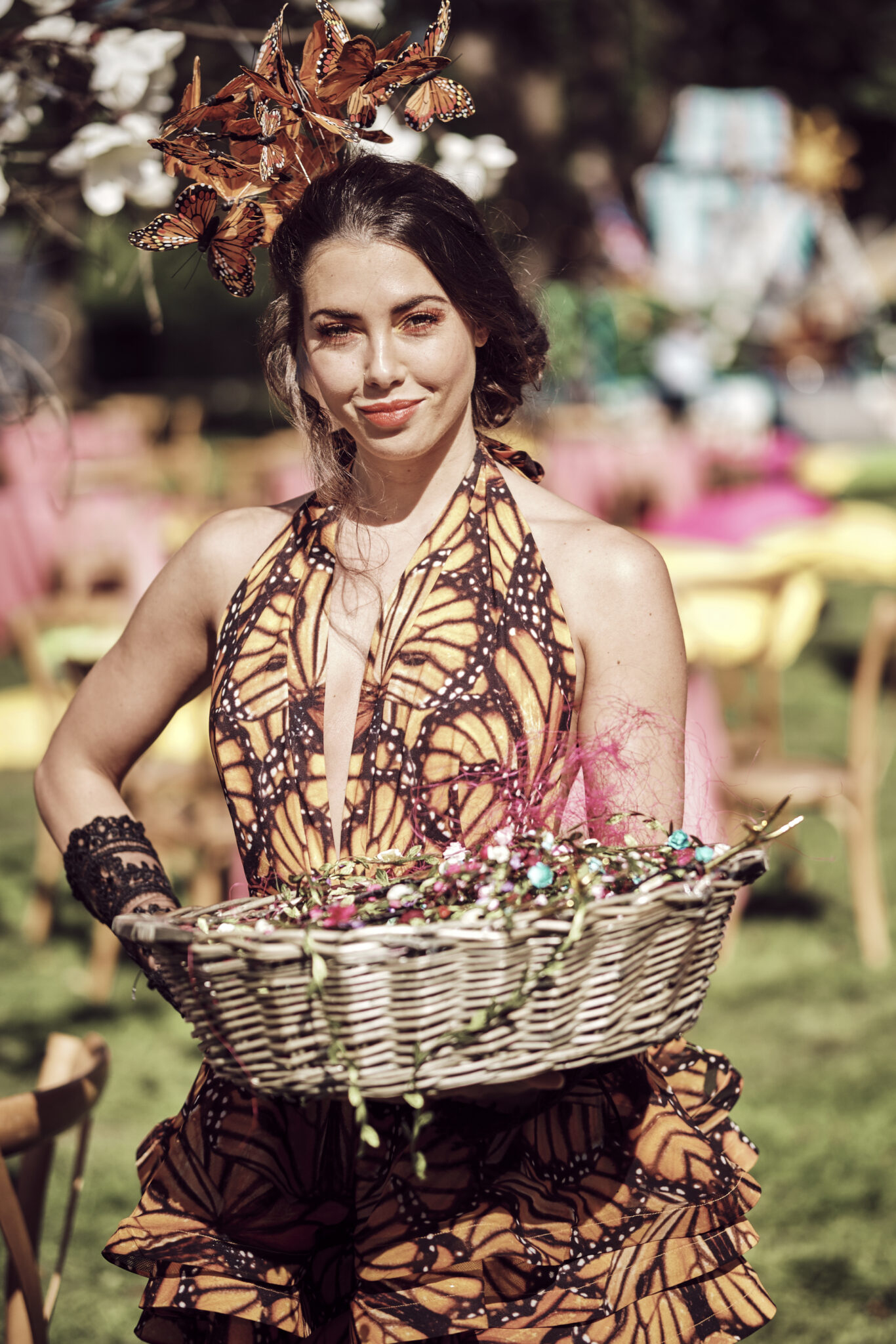 Butterfly Sophie and Eloise Lovell as event hosts dressed as monarch butterflies at an enchanted garden party.