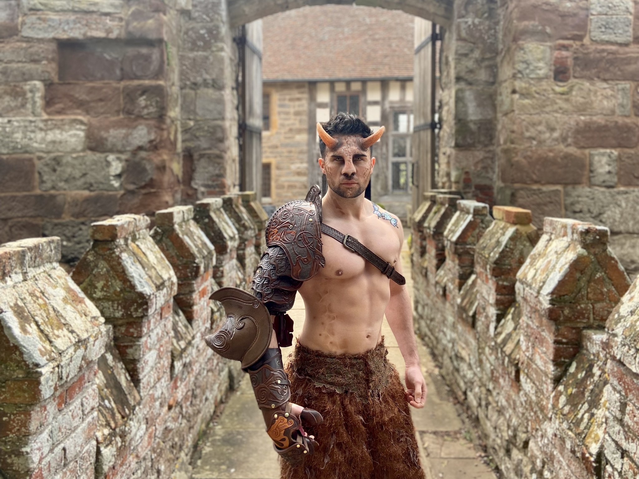 Enchanted Forest Garden Party Entertainment A Faun in ornate leather armour standing on the drawbridge of a castle