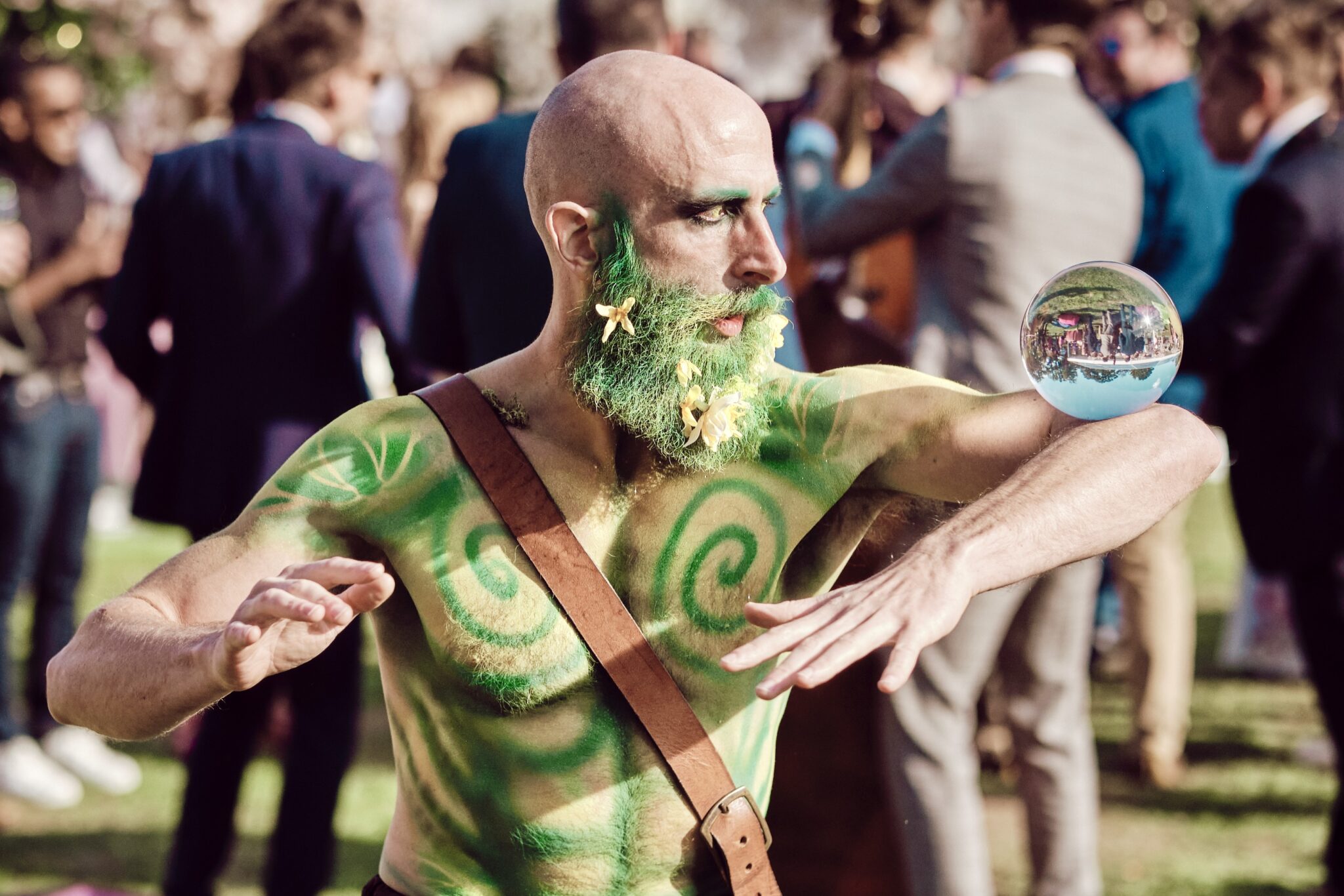 Green_man_contact_juggler A contact juggler at a midsummers night dream themed garden party. The performer is dressed as the green man featuring body art and natural textures
