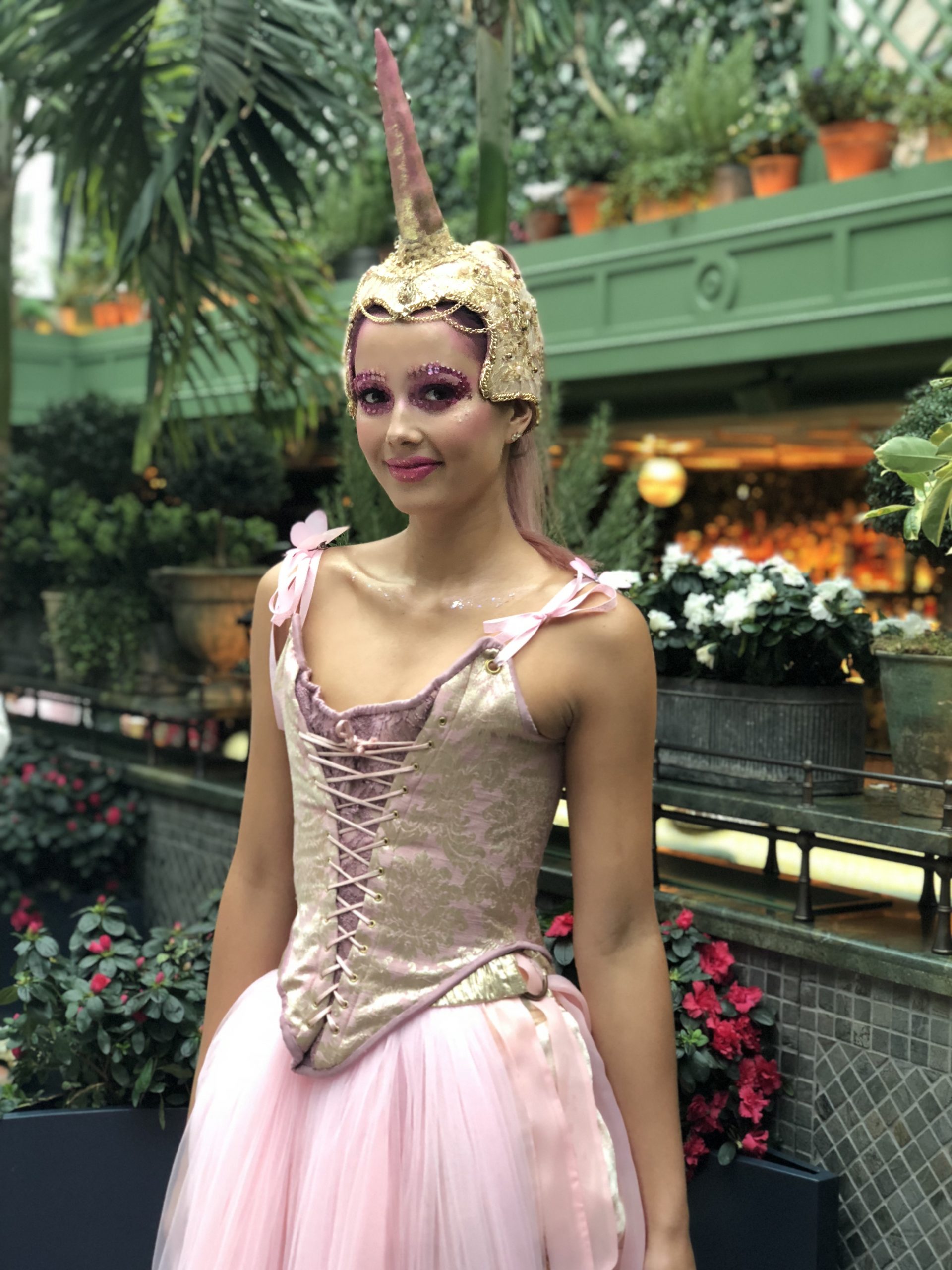 Unicorn costume fancy dress in an enchanted garden