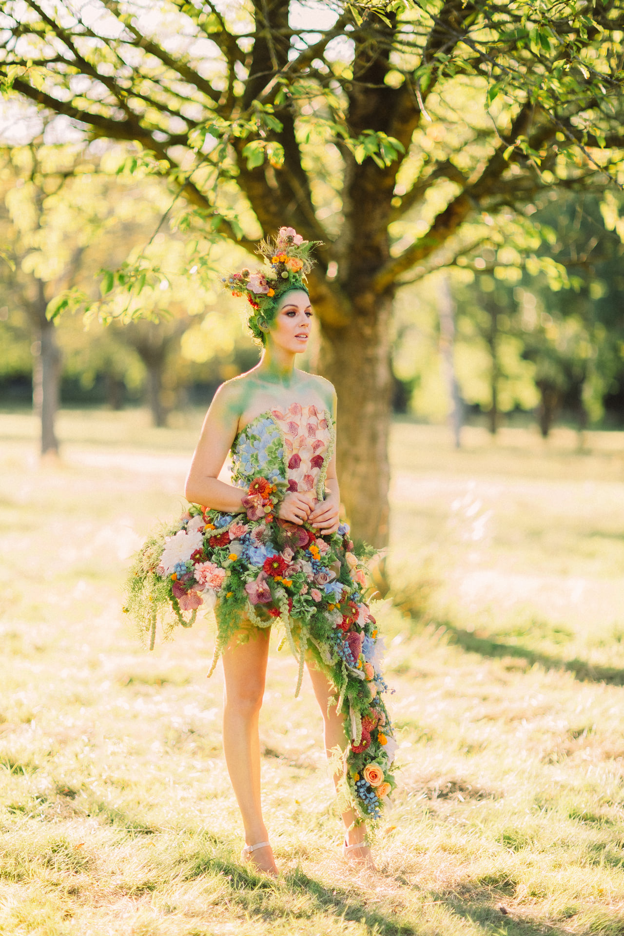 Flower fairy in a real flower dress in a meadow