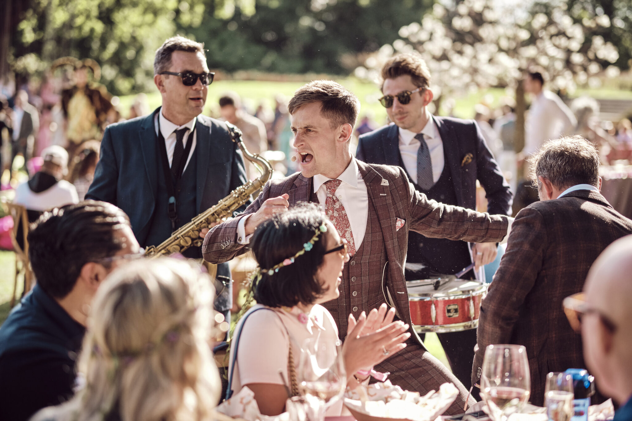 Roving Band A roving band entertain guests at a midsummers night dream themed enchanted garden party